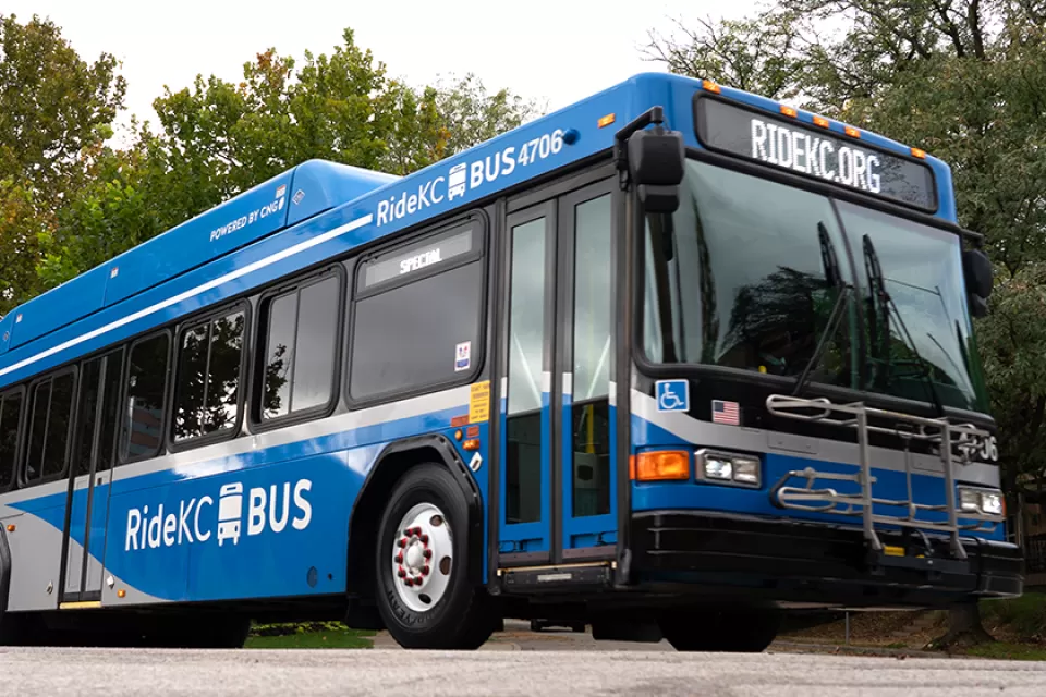 Blue RideKC bus in Kansas City with trees in background